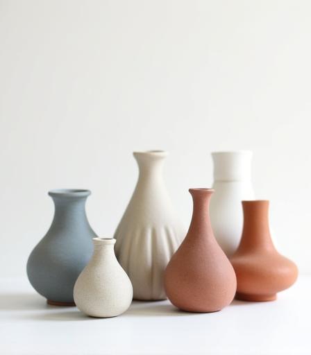 A collection of minimalist artisanal ceramic vases.